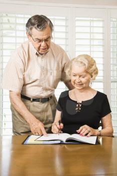 Royalty Free Photo of an Older Couple Looking at Their Calendar