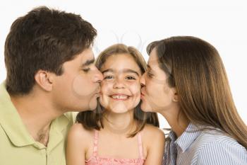 Royalty Free Photo of a Mother and Father Kissing Their Smiling Daughter on the Cheek