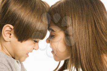 Royalty Free Photo of a Boy and Girl With Heads Together Making Mean Faces