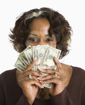 Royalty Free Photo of a Woman Holding Money in Front of Her Face