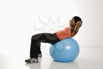 Royalty Free Photo of a Woman Working Out With an Exercise Ball