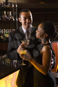 Royalty Free Photo of a Couple Having Drinks at the Bar