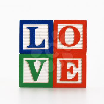 Stack of alphabet toy building blocks spelling the word love.
