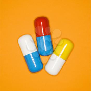 Medical pills on a orange background.