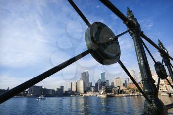 Royalty Free Photo of Sydney Cove From Behind a Decorative Iron Railing With City Skyline and Water in Sydney, Australia