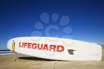 Lifeguard surfboard on beach in Surfers Paradise, Australia.