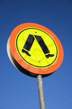 Royalty Free Photo of a Pedestrian Crosswalk Sign With Blue Sky in Australia