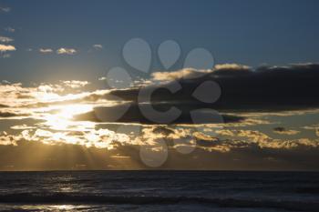 Royalty Free Photo of Cumulus clouds at sunset over ocean in Surfers Paradise, Australia