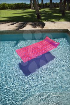 Royalty Free Photo of a Pink Float in an Empty Swimming Pool