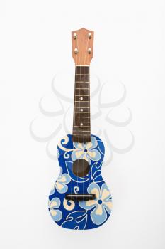 Royalty Free Photo of a Ukulele Painted With Blue Flowers