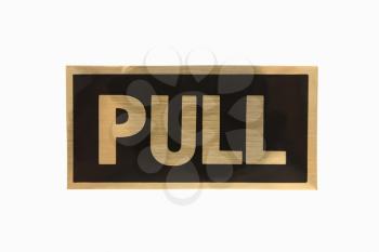 Royalty Free Photo of a Pull Sign With Gold Text