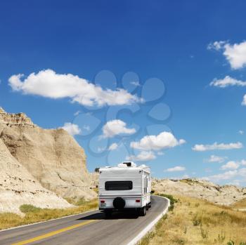 Royalty Free Photo of a Recreational Vehicle on a Scenic Road in Badlands National Park, North Dakota