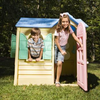 Royalty Free Photo of a Brother and Sister Playing in a Playhouse