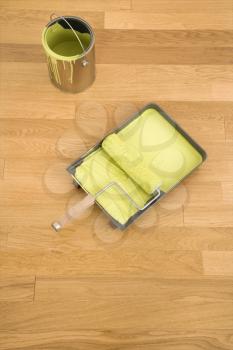 Royalty Free Photo of a Paint Roller in a Tray With a Paint Can on a Wood Floor