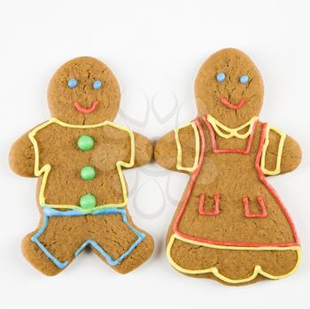 Male and female gingerbread  cookies holding hands.