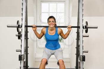 Royalty Free Photo of a Woman Lifting Weights in a Gym