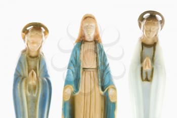 Royalty Free Photo of a Virgin Mary Statue With Hands Held Out With Angelic Figures on Each Side