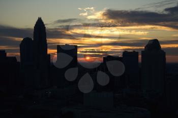 Royalty Free Photo of Sunset Silhouetting an Aerial View of Charlotte, North Carolina City Skyline