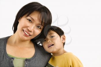 Royalty Free Photo of an Asian Mother and Son Leaning on One Another