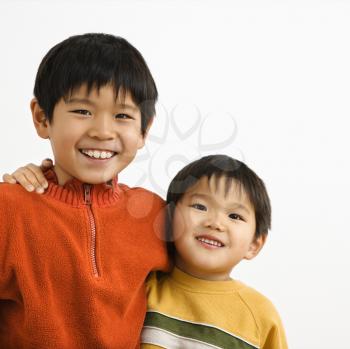 Royalty Free Photo of Brothers with Arms Around Each Other Smiling