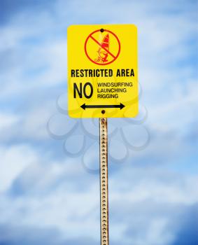 Royalty Free Photo of a Sign Near the Ocean or Lake Warning of No Windsurfing, Rigging or Launching