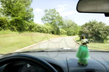 Royalty Free Photo of a Hula Girl on a Dashboard