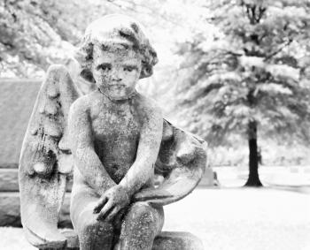 Royalty Free Photo of a Statue of a Cherub in a Graveyard