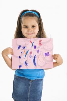 Royalty Free Photo of a Smiling Girl Proudly Holding a Drawing