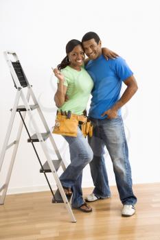 Royalty Free Photo of a Smiling African American Couple Preparing to Do Home Repairs
