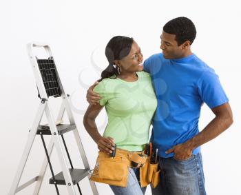 Royalty Free Photo of a Smiling African American Couple Preparing to Do Home Repairs