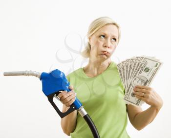 Royalty Free Photo of a Woman Holding a Gas Nozzle and Money 