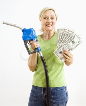 Royalty Free Photo of a Woman Holding a Gas Nozzle and Money