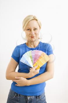 Royalty Free Photo of a Smiling Blonde Woman Holding Paint Swatches