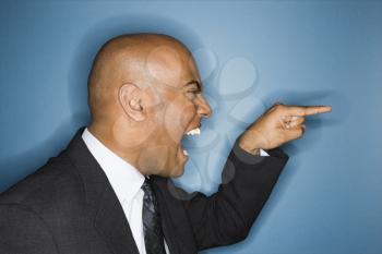 African American businessman screaming and pointing. 