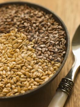 Royalty Free Photo of a Dish of Golden and Brown Linseed