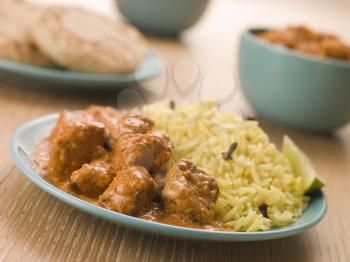 Royalty Free Photo of Plated Chicken Korma With Pilau Rice and Naan bread