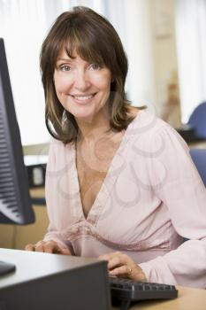 Royalty Free Photo of a Woman Sitting at a Computer