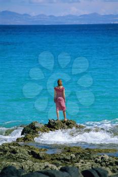 Royalty Free Photo of a Woman Standing at the Water's Edge