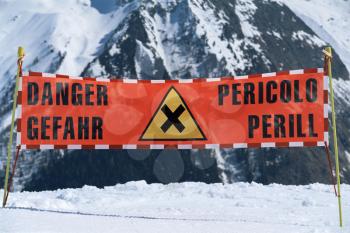 Royalty Free Photo of a Danger Sign on a Snowy Mountain