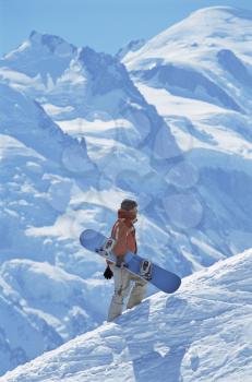 Royalty Free Photo of a Snowboarder Going Uphill