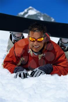 Royalty Free Photo of a Snowboarder Lying in the Snow