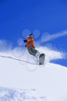 Royalty Free Photo of a Snowboarder Coming Down a Slope