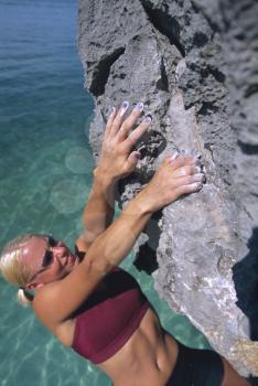 Royalty Free Photo of a Woman Climbing Rocks