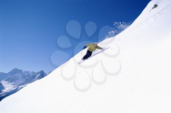 Royalty Free Photo of a Person Coming Down a Snowy Hill