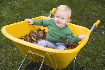 Royalty Free Photo of a Baby in a Wheelbarrow