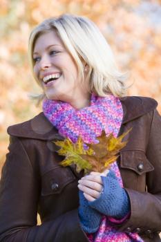 Royalty Free Photo of a Woman Holding Autumn Leaves