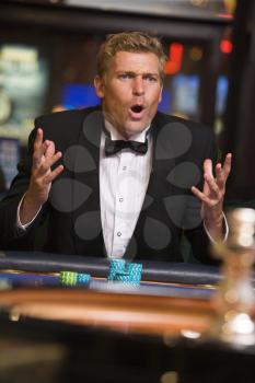 Royalty Free Photo of a Man Losing at a Roulette Table