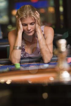 Royalty Free Photo of a Woman Losing at Roulette