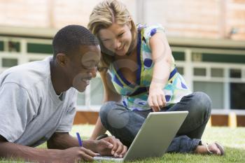 Royalty Free Photo of Students on the Lawn With a Laptop