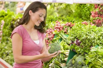 Royalty Free Photo of a Woman Shopping for Broccoli